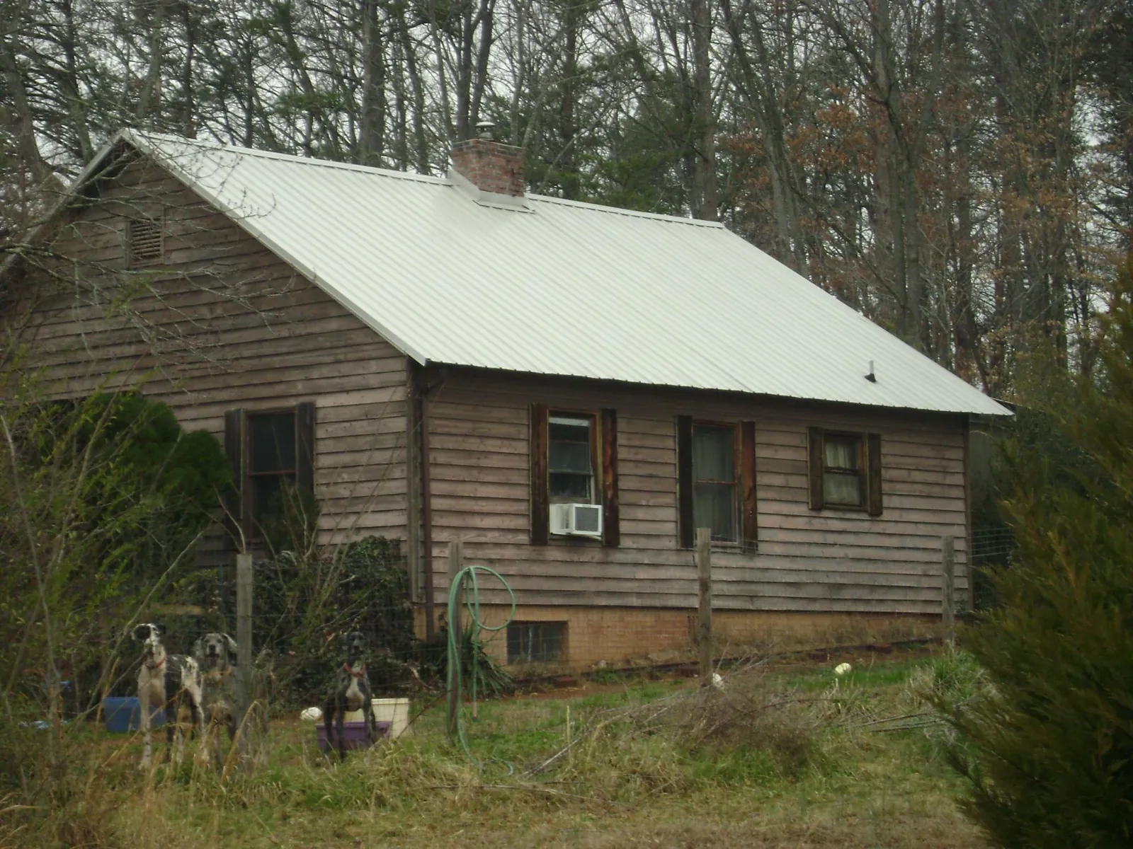 White metal roof on an old wood sided farmhouse, from a Metal Roof Installation job in Aaronsburg